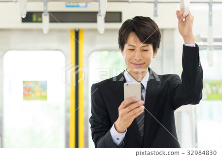 Business person (smartphone, train) photography cooperation "Keio Electric Railway Co., Ltd." Business person (smartphone, train) photography cooperation "Keio Electric Railway Co., Ltd." 32984830