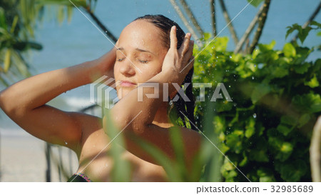 Beautiful young woman in outdoor shower. Sensual Beautiful young woman in outdoor shower. Sensual 32985689