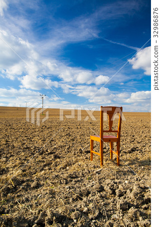 Old wooden chair on the empty field Old wooden chair on the empty field 32986876