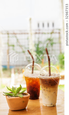 iced latte and americano coffee on a wooden table. 32987353