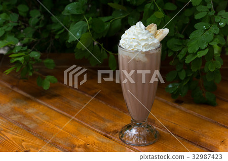 banana smoothie in a glass On a wooden background 32987423