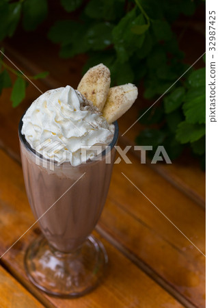 banana smoothie in a glass On a wooden background 32987425