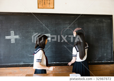 High school girl writing on a blackboard High school girl writing on a blackboard 32987872