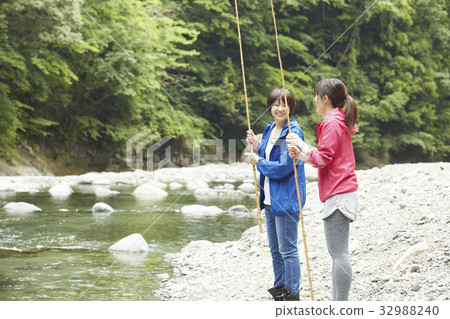 A woman enjoying fishing A woman enjoying fishing 32988240