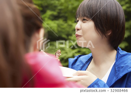 A woman enjoying a barbecue 32988466