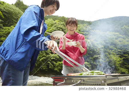 A woman enjoying a barbecue A woman enjoying a barbecue 32988468