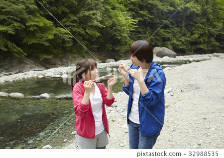 A woman enjoying a barbecue 32988535