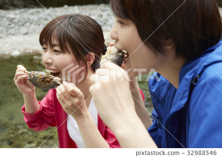A woman enjoying a barbecue A woman enjoying a barbecue 32988546