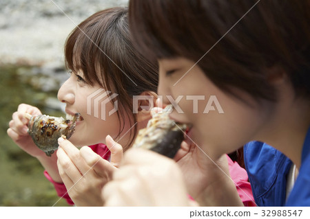 A woman enjoying a barbecue A woman enjoying a barbecue 32988547
