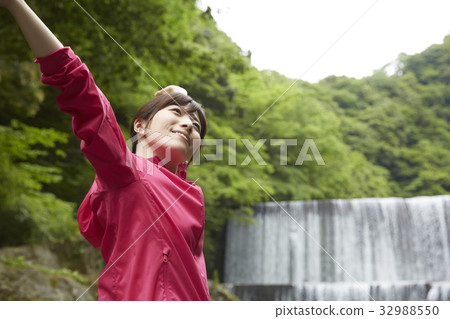 Woman relaxing at the riverbank 32988550