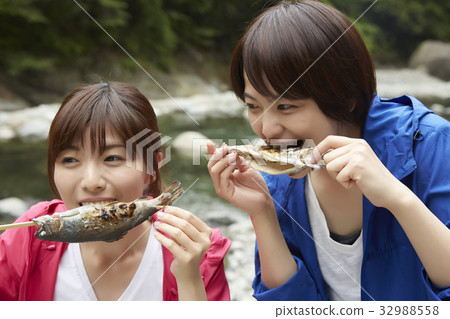 A woman enjoying a barbecue 32988558