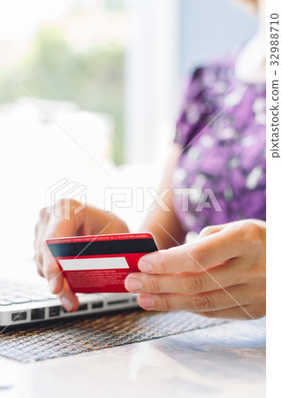 Woman with laptop and credit card in the cafe. Woman with laptop and credit card in the cafe. 32988710
