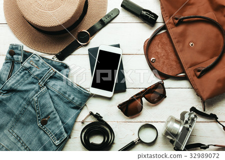 Top view accessories to travel with women clothing 32989072