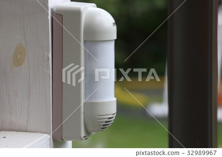 Outdoor motion detector on the white post 32989967