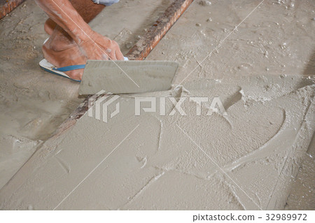 Builders are pouring concrete floors. For construc Builders are pouring concrete floors. For construc 32989972