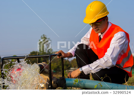 Young engineers are checking the water pump. Young engineers are checking the water pump. 32990524