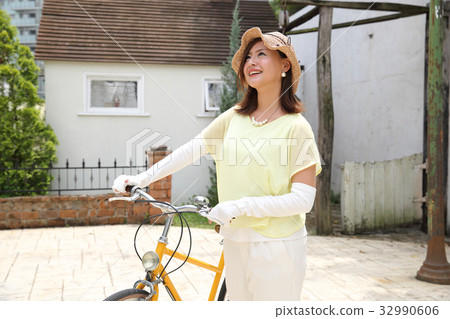 Woman riding a bicycle Woman riding a bicycle 32990606