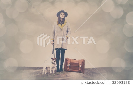 portrait of young woman with suitcase and dog portrait of young woman with suitcase and dog 32993128