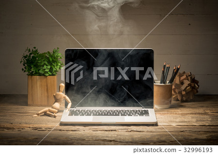 The front view of notebook and wooden doll 32996193