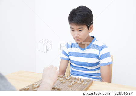 Boy pointing at shogi Boy pointing at shogi 32996587