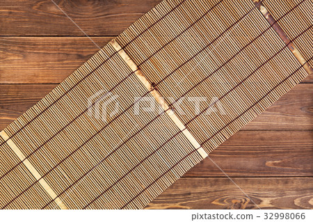 Bamboo mat for sushi on wooden background. Bamboo mat for sushi on wooden background. 32998066