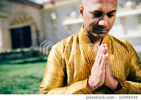 Indian Man Namaste in Gold Kurta at the Temple 32999348