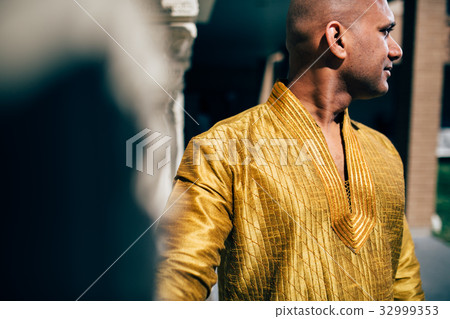 Handsom Indian Man in Gold Kurta at the Temple Handsom Indian Man in Gold Kurta at the Temple 32999353