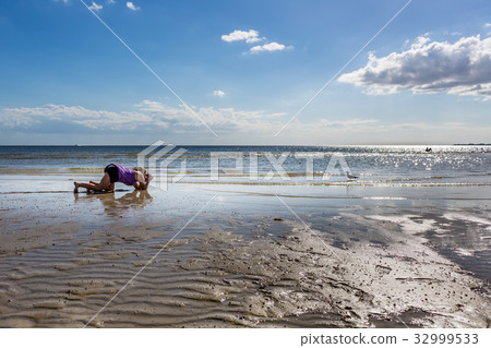 Photographing a seagull on the beach Photographing a seagull on the beach 32999533