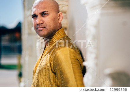 Handsom Indian Man in Gold Kurta at the Temple 32999866