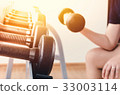Hand of woman taking a dumbbell 33003114
