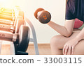 Hand of woman taking a dumbbell 33003115