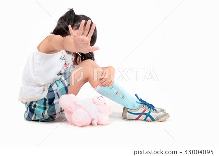 Scared girl making stop gesture with her hand 33004095