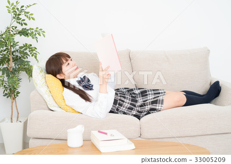High school girl looking at notebook in living room 33005209