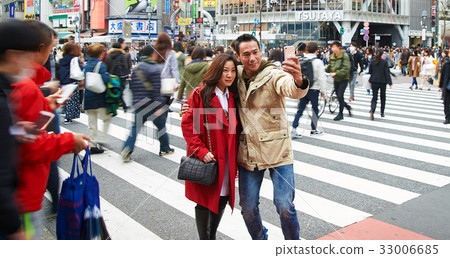 A picture of a couple taking photo on the street A picture of a couple taking photo on the street 33006685