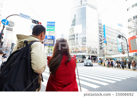 a picture of a woman and her husband standing on the street 33006692