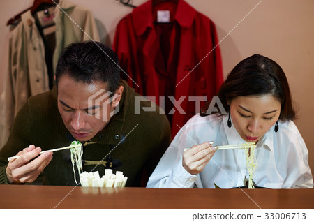 A picture of a couple eating ramen together A picture of a couple eating ramen together 33006713