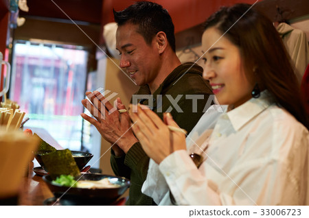 two people are praying together before they eat 33006723