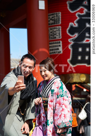 The portrait of a couple taking photos and selfie by smartphone 33006969