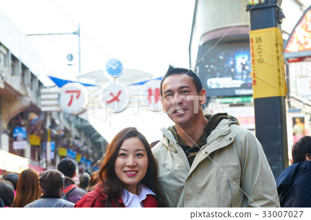 a photo of a couple smiling and looking at camera. a photo of a couple smiling and looking at camera. 33007027