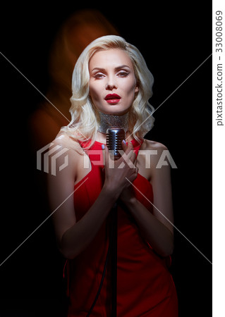 Girl singing into the microphone. Girl singing into the microphone. 33008069