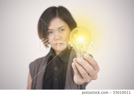 Business women hand holding light bulb. Business women hand holding light bulb. 33010011