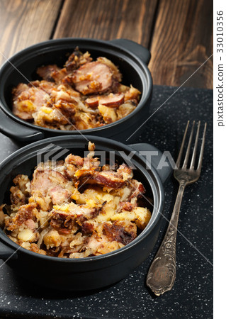 Potatoes baked with sausage and bacon Potatoes baked with sausage and bacon 33010356