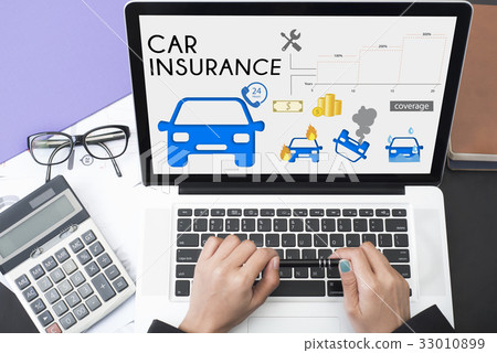 hand using computer with car insurance policy page 33010899