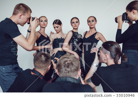 Photographers paparazzi take photos of women in 33010946