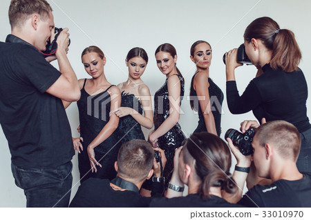 Photographers paparazzi take photos of women in 33010970