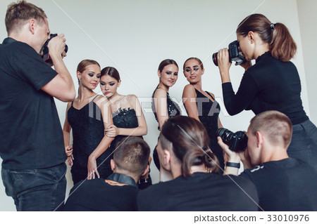 Photographers paparazzi take photos of women in 33010976