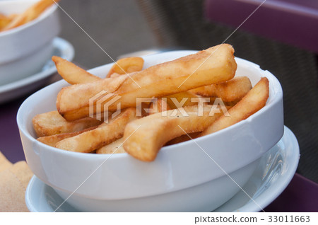 closeup of french fries in a bowl at restaurant 33011663