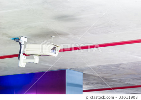 Modern security camera on the indoor concrete wall Modern security camera on the indoor concrete wall 33011908