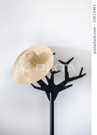 Straw hat on hanger, white background. Straw hat on hanger, white background. 33013461