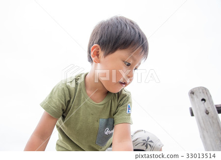 A boy playing in a park A boy playing in a park 33013514